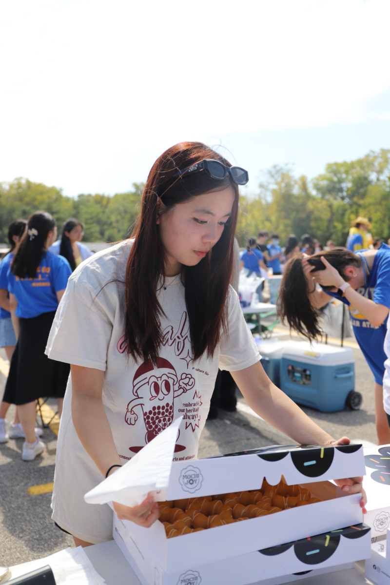 Ava Luo, vice president of A5 and senior, helps run the A5 Homecoming booth on Sept. 20, 2024. Club sponsor Allison Hargrove said the success of the Homecoming booth has made her excited for the rest of the year. 