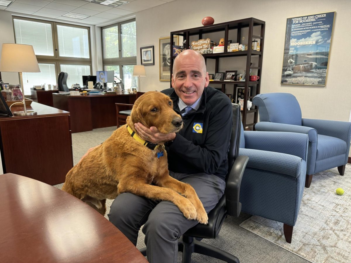 Superintendent Michael Beresford poses with his service dog on Sept. 12. Beresford said it's important to research the candidates for the school board race.