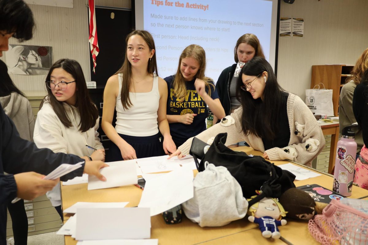 Junior Rachel Engbrecht (second to left) and other members of the CHS Artist’s Association participate in an art activity involving collaboration at CHS on Aug. 27, 2024. They had to draw different body parts separately to create one original character. “I liked that we each could add our own part to it and surprise each other once it was complete,” said Engbrecht.