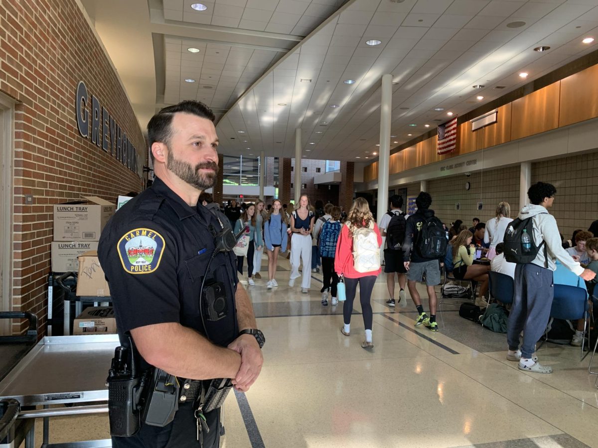 SRO Hunter Rogowski stands watching Greyhound Station on the morning of Sept. 10 as a part of his daily door duty. Rogowski said he enjoys forming bonds and connecting with students.