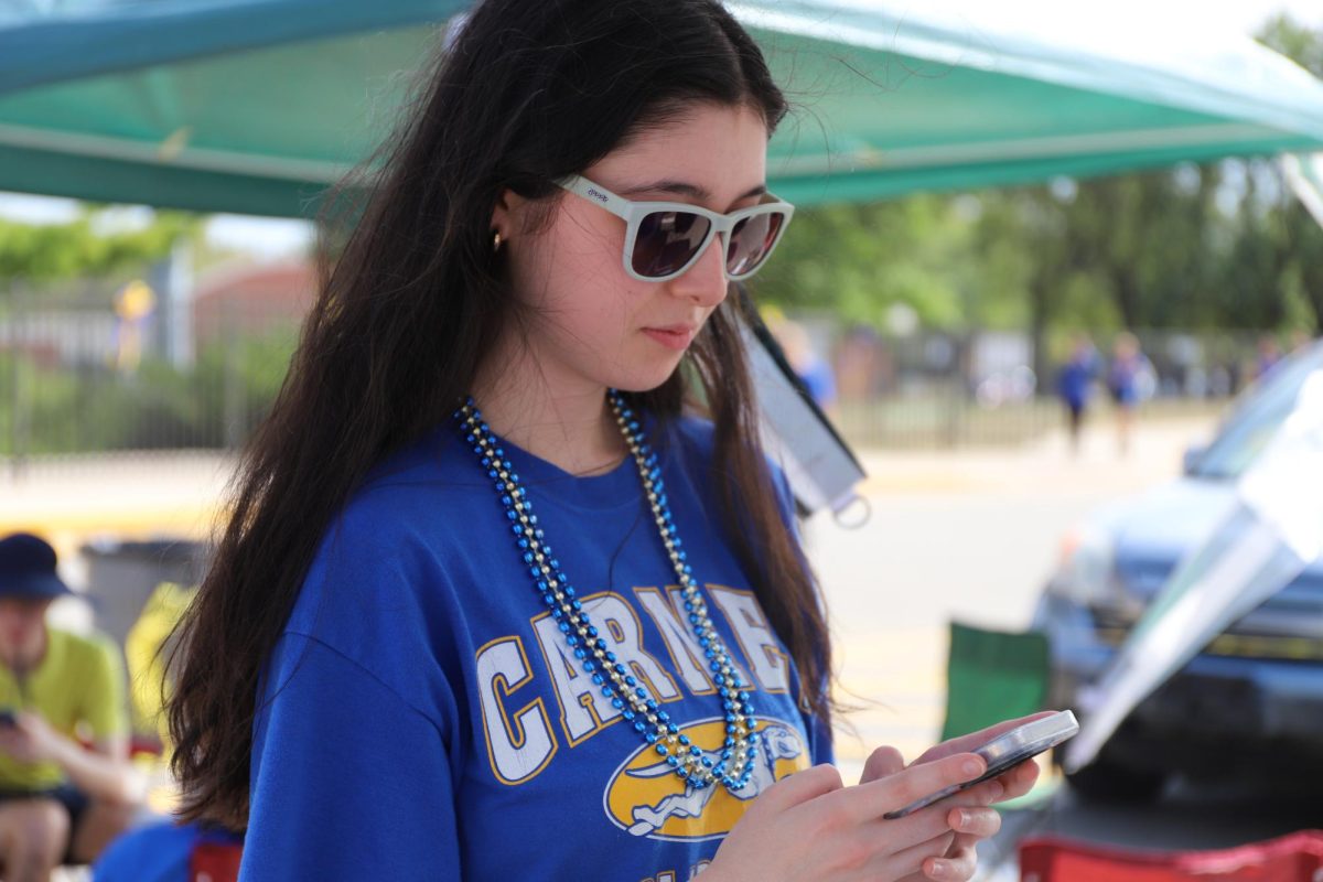 Senior Jossi Sorg communicates with friends using inside jokes and new slang at the homecoming pep rally on Sept. 20. Sorg said, “Slang is ever-changing, it will continue evolving. In the 80s and 90s, people used words that aren't relevant today and that will happen for this generation's slang terms."