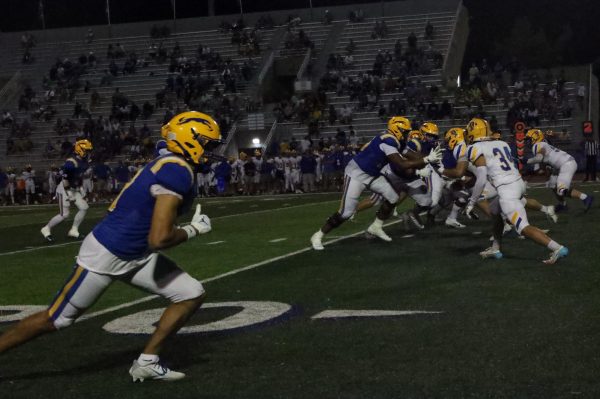 Members of the Carmel football team face off against Homestead on Aug. 23 at home. Anthony Coellner, quarterback and junior, said the team has continued to improve since the beginning of the season.
