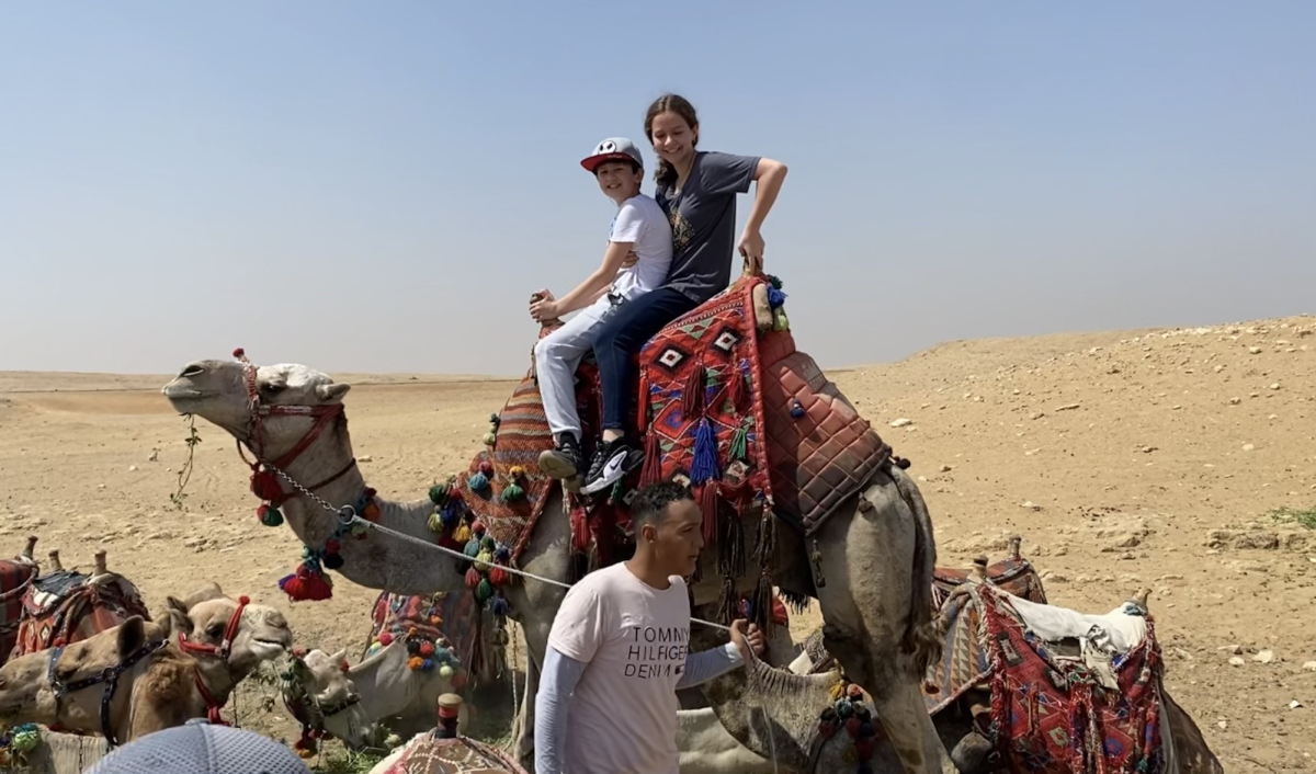 Freshman Sofia Ludington-Barquet rides atop a camel on her way to the Great Pyramids at Giza on Monday, May 29, 2023. “To touch, feel, smell---and just be there---was so much better than looking at the magazine that I had looked at all my life. It truly was incredible,” said Ludington-Barquet. (Submitted Photo: Sofia Ludington Barquet)