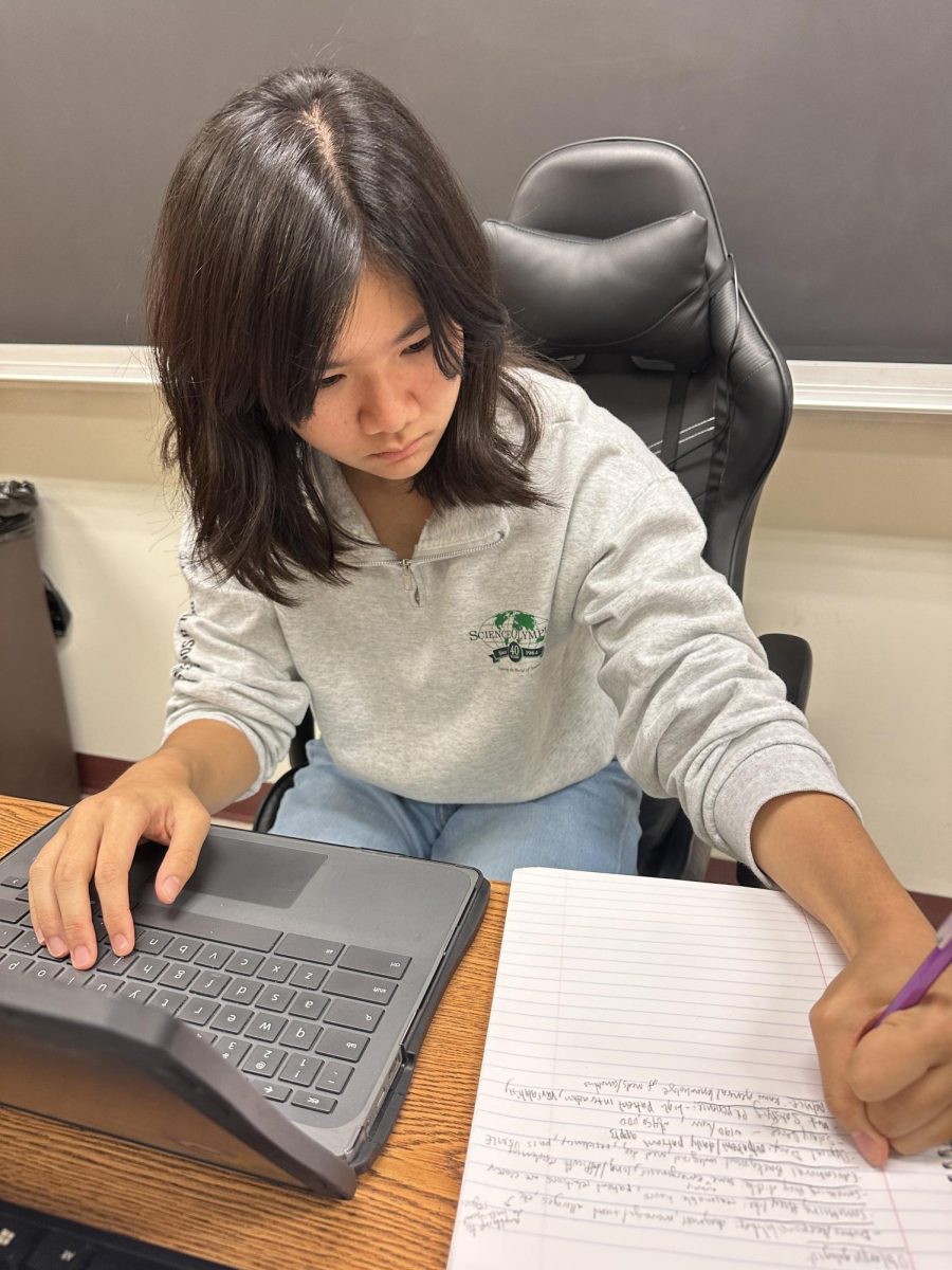 Science Olympiad officer and sophomore Ava Liao finishes up grading tryout tests. She said a lot of people did well in their events. 