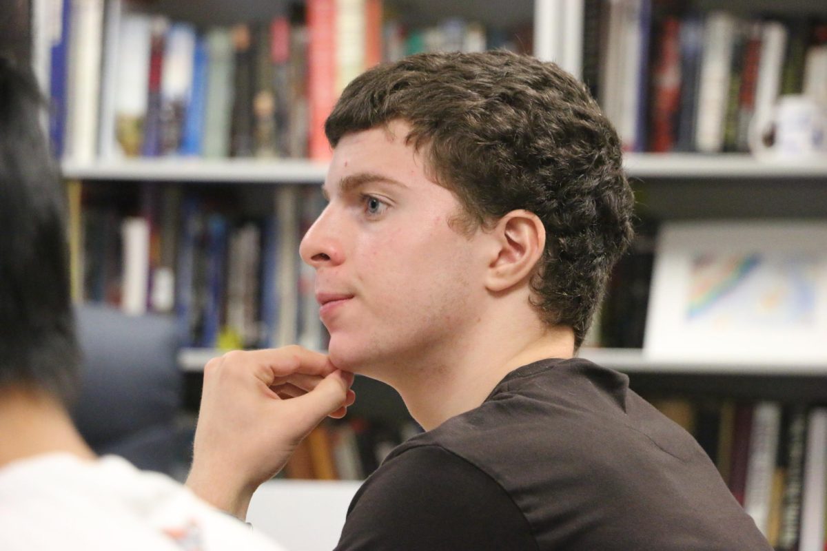 Sophomore Fahed Badreddine listens attentively in his AP African American Studies class as his teacher, Mr. Ziegler, discusses LatinX Heritage month for the class bellringer on Oct. 1, 2024. The class was designed to provide accurate representation by providing more nuanced and up-to-date historical analysis on African American history. “In this class, I've learned that (African Americans) they're a lot more successful than what society and what (typical) textbooks portray them as,” Badreddine said.