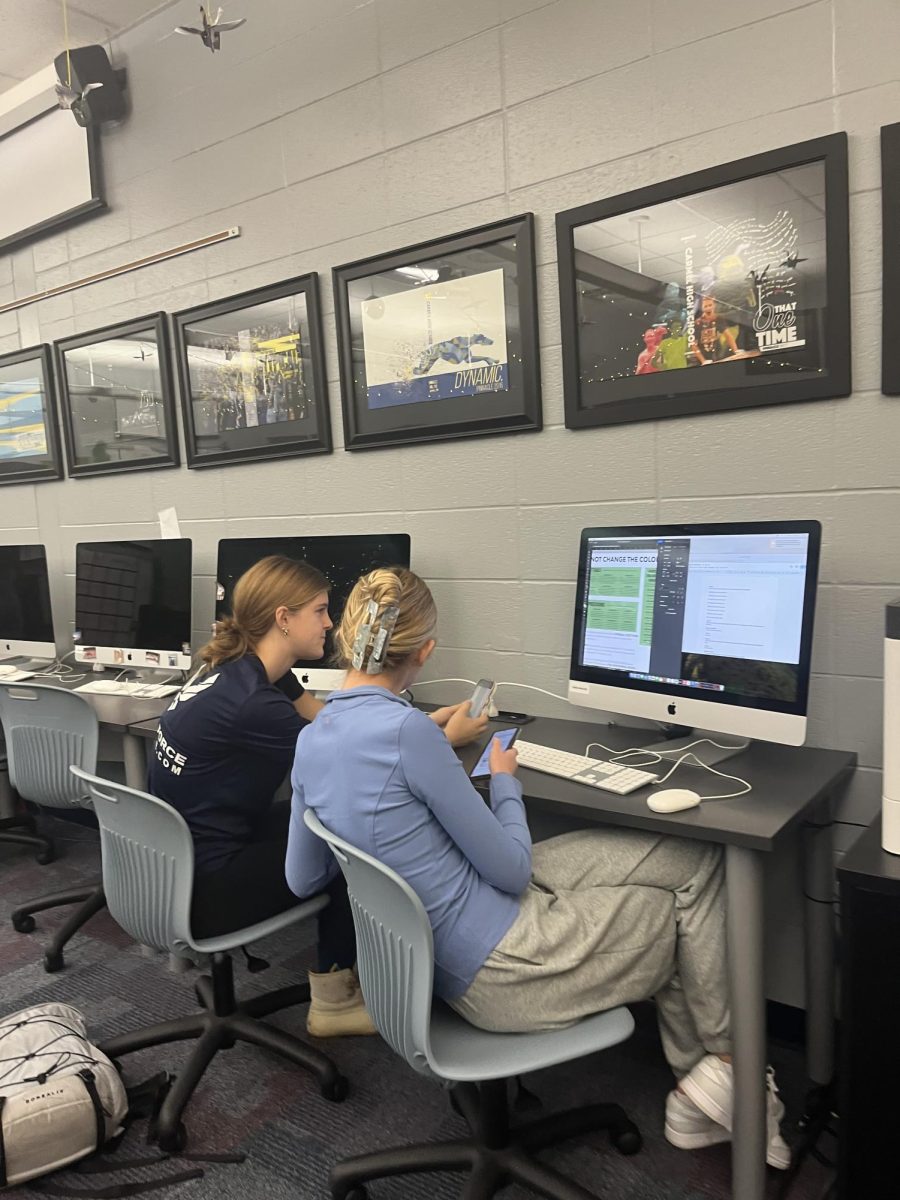 Pinnacle members Sophie Collier and Ella Fisher work on yearbook spreads. Fisher said, “Yearbook is such a good community, I’m so glad I get to be a part of it.” 
