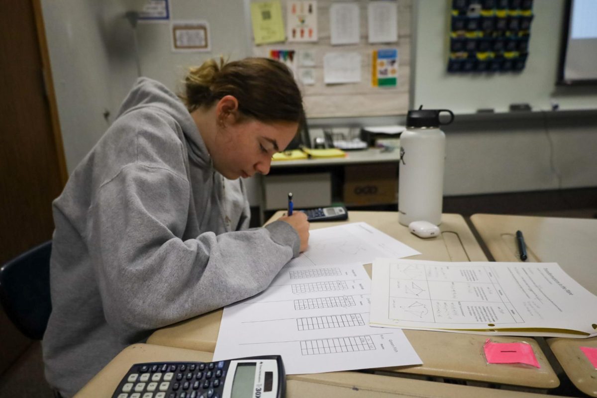 Sophomore Taylor Allen works on her PSAT prep papers during her G1 geometry class on Oct. 15, 2024 in Tess Courtade’s room. She successfully completed her practice and continued to review for the upcoming exam. “I’m a little nervous about the PSAT, I’m not sure how well it’s going to go, I think I’ll be fine though,” Allen said.