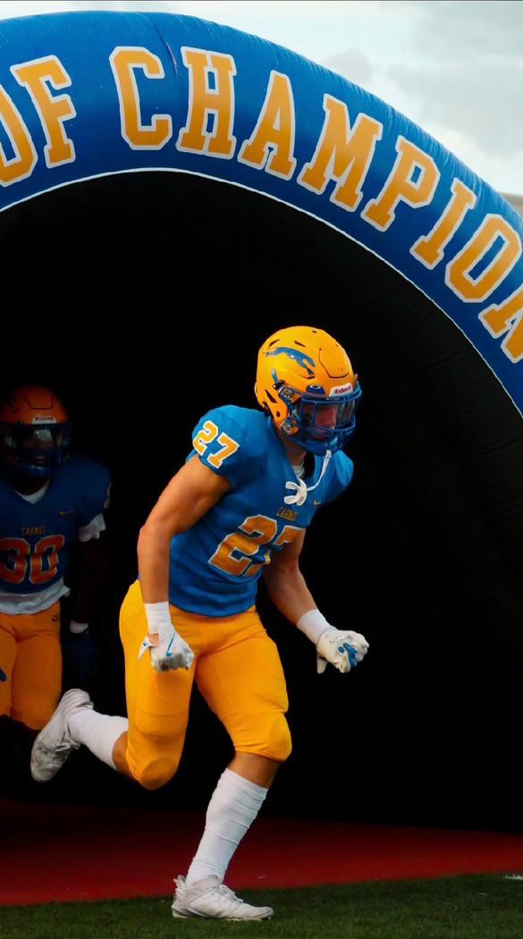 Junior Aaron Fedorcha runs out of the tunnel to prepare for the football game ahead of him. The game was against Trinity Kentucky at home.
