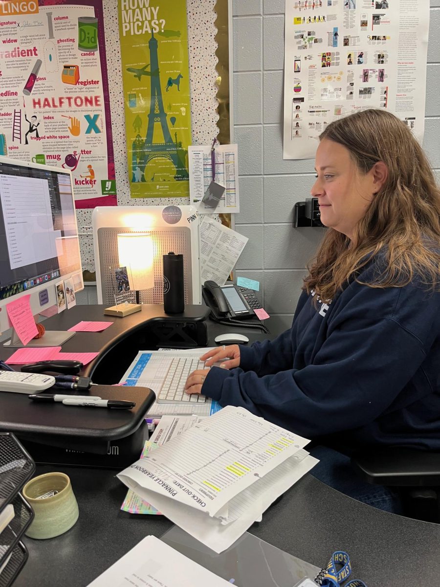 Pinnacle staff adviser Claire Burke works on her computer. Burke said, “We have completed a good bit of the yearbook. I am looking forward to finishing out the semester strong!”