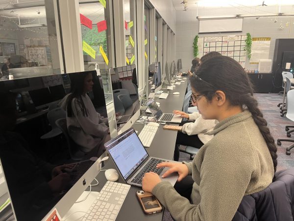 
Caption: Bhavana Rupesh works on her computer during SSRT. She said,  “My favorite thing about being on staff is the community, we slowly get to know each other and our work gets better throughout the year.”