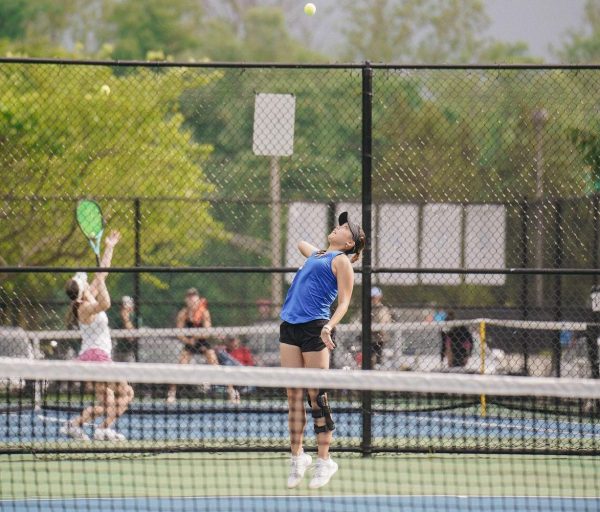 Senior Grace Kim plays tennis with a brace after recovering from her ACL tear. Kim said she's played more cautiously since she sustained her injury. (Submitted photo: Grace Kim)