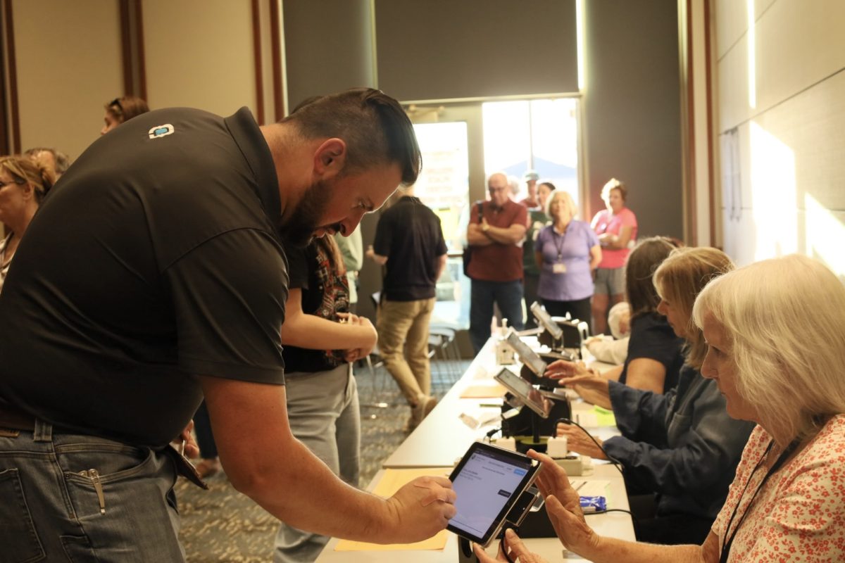 An early voter is entering the information required to cast a ballot at the CCPL on Oct. 30 for the 2024 election. Nie said people being more bipartisan and willing to listen to each other will help the partisan divide. 