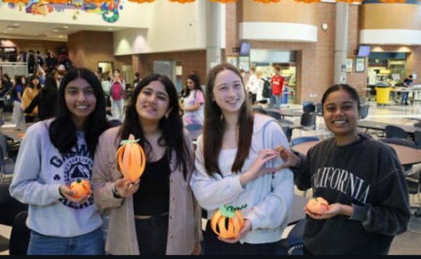  Key Club class officers hold their craft pumpkins they made at a Carmel Key Club meeting on Nov. 2. Key Club officer Vritika Arya said Carmel Key Club makes it a priority to give back to the community. 