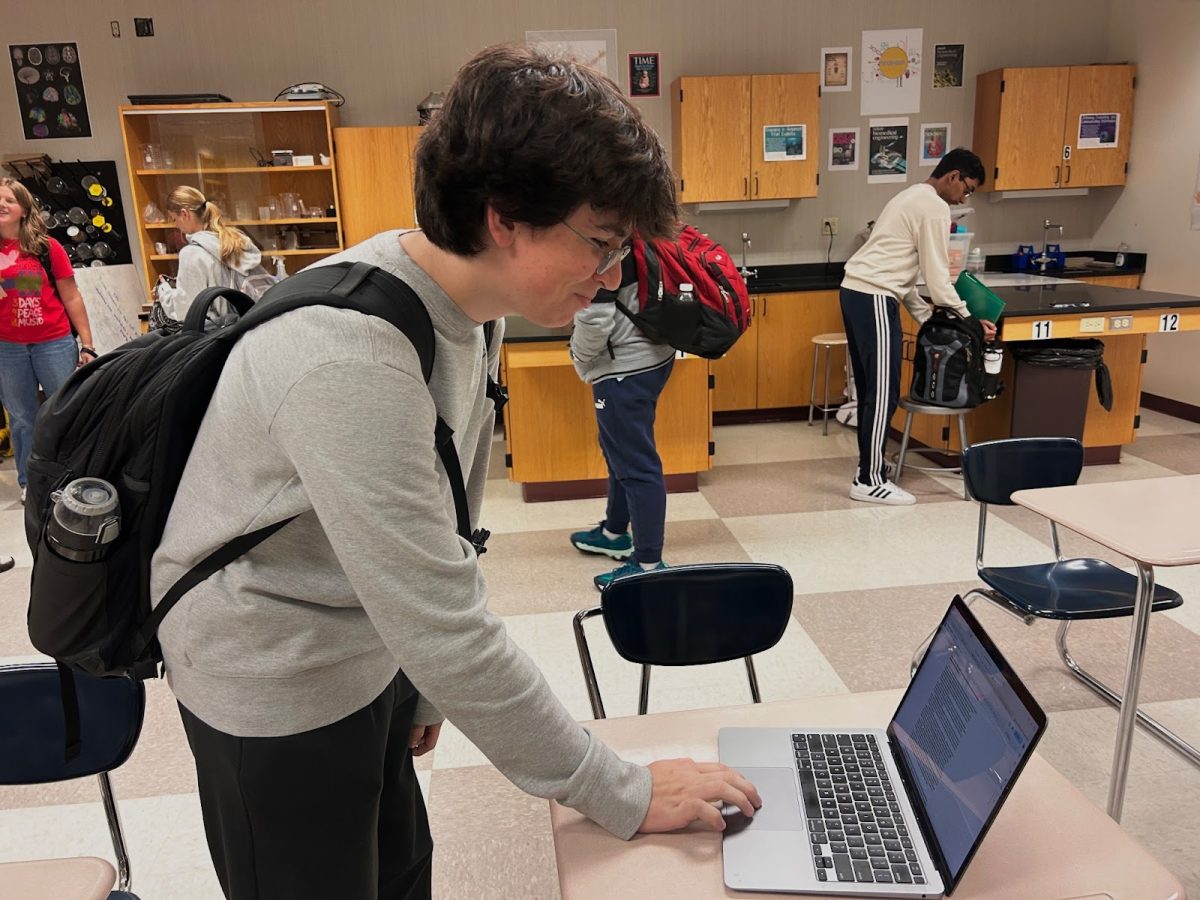 Senior Chris Tichindilean reviews his creative writing piece he prepared for the creative writing club.