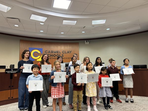 CCS Young Artist Award Winners receive their certificates at the Nov. 11 school board meeting. Recipients were selected for the creativity and details displayed in their artwork.