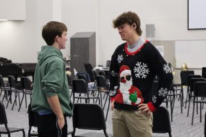 Junior Marcus Grethen talks to a friend while wearing an ugly sweater. Grethen competes to create the ugliest sweater in his family’s holiday competition.