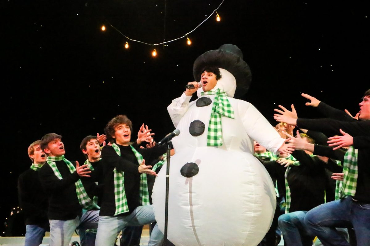 Isaiah Henderson, Ambassador's member and senior, performs his solo for the song "The Greatest Snow" alongside Greyhound Sound members on Dec. 3 in the Dale E. Graham Auditorium for the final rehearsal of Holiday Spectacular. Holiday Spectacular was split into two different acts with an intermission in between. 