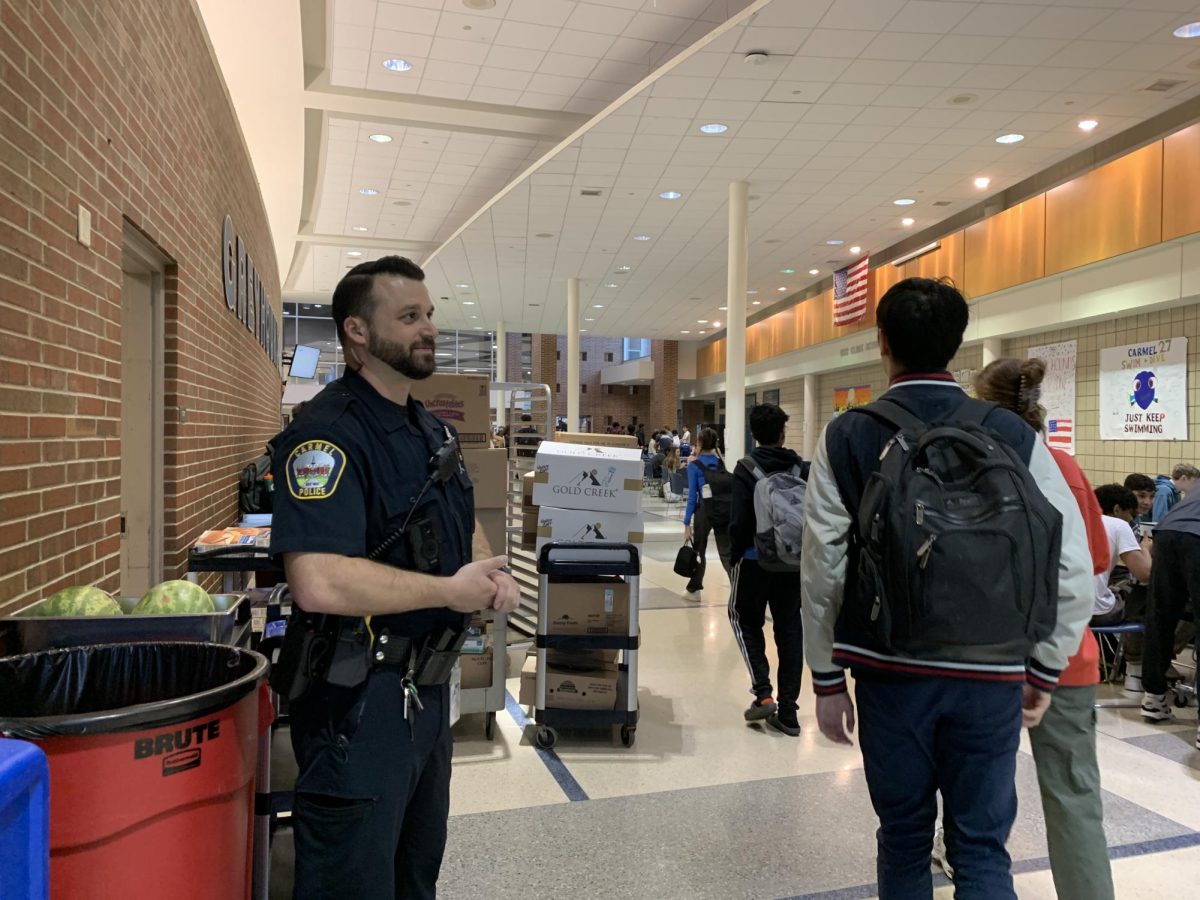 SRO Hunter Rogowski monitors the Greyhound Cafeteria on Nov. 19 as a part of his daily routine. Rogowski said on top of forming connections with students, he also works with teachers in classrooms.