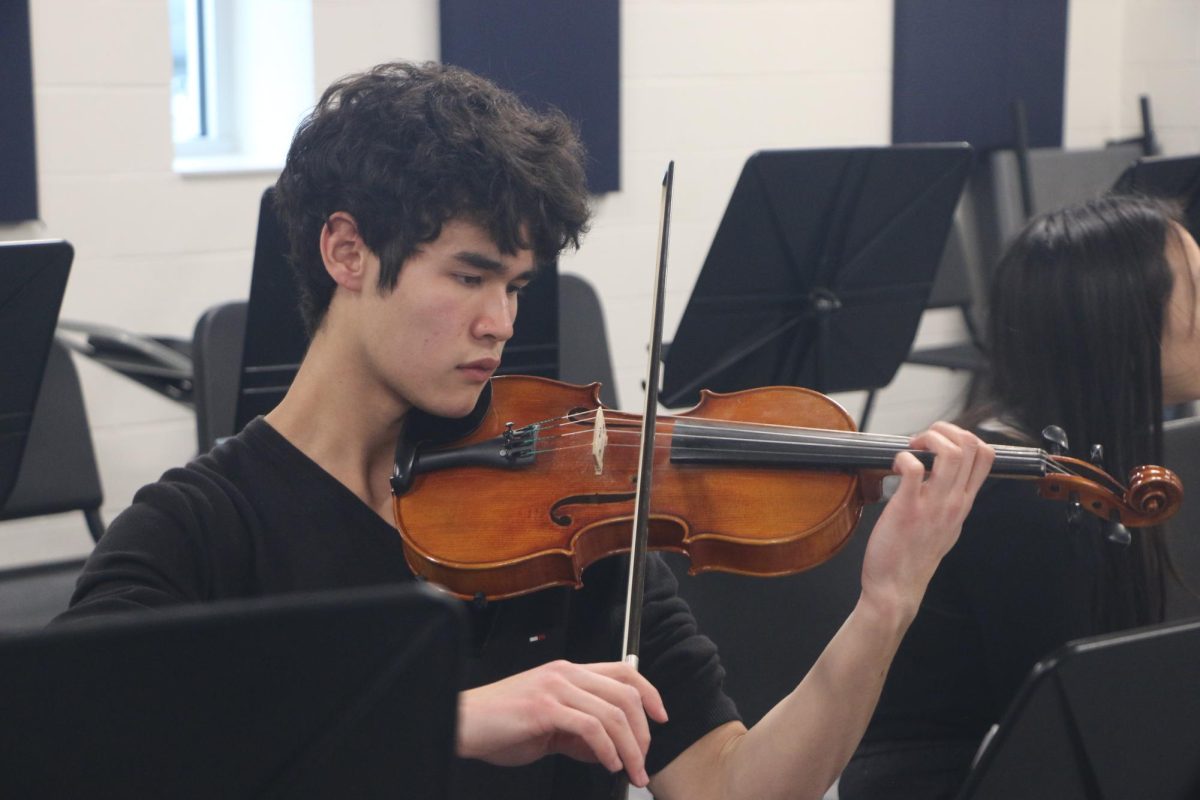 Senior Kaden Rush practices a piece on the violin during the Cultural Exchange Project’s performance rehearsal at CHS on Dec. 9, 2024. As the president of CEP, Rush handled scheduling meetings throughout the year. 