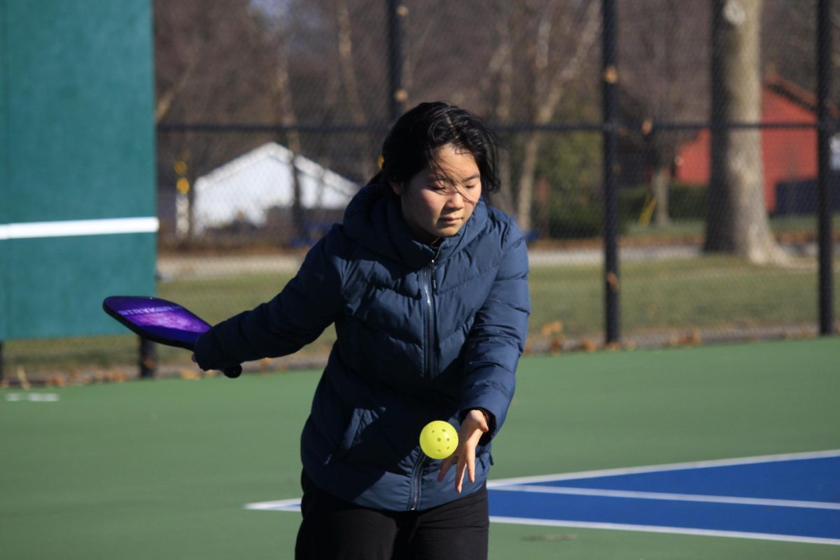 Sophomore Stephanie Tan plays pickleball. on a court. Tan said, "You don't have to play for a long time to have a good game.” 