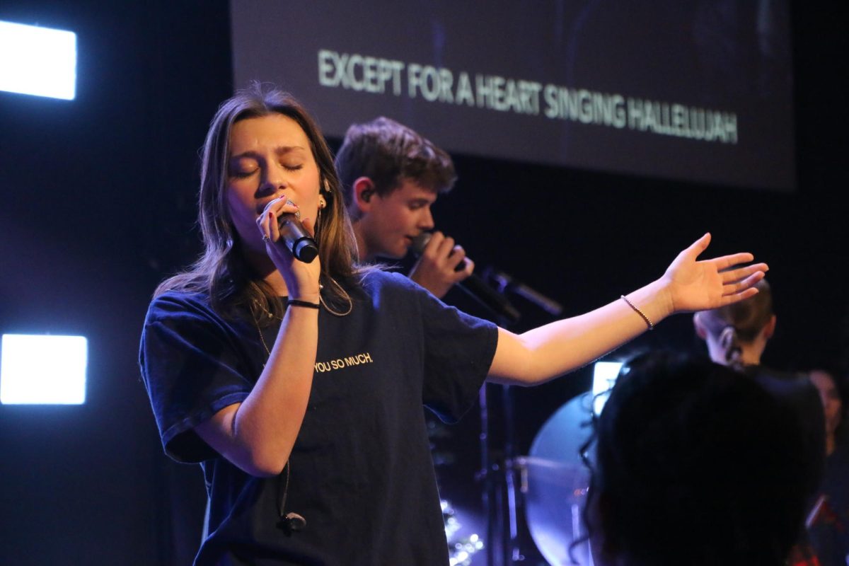 Junior Faith Spittal sings worship during youth group at Mercy Road Church on December 15th. The song brought a sense of peace to the service.