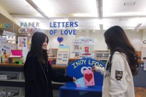 Junior Jessica Flowers and freshman Amy Luo send off their letters using the Letters of Love drop-off box. The club members painted and decorated the box themselves, according to sophomore and club president Angela "Angie" Xiu. (Submitted photo: Angie Xiu)