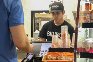 An employee takes an order at BIBIBOP, one of the restaurants attending Taste of Carmel. Sophomore Sophie Imler said, “Trying new foods from other cultures has made me feel closer to friends. It’s helped me feel more comfortable around them now.”