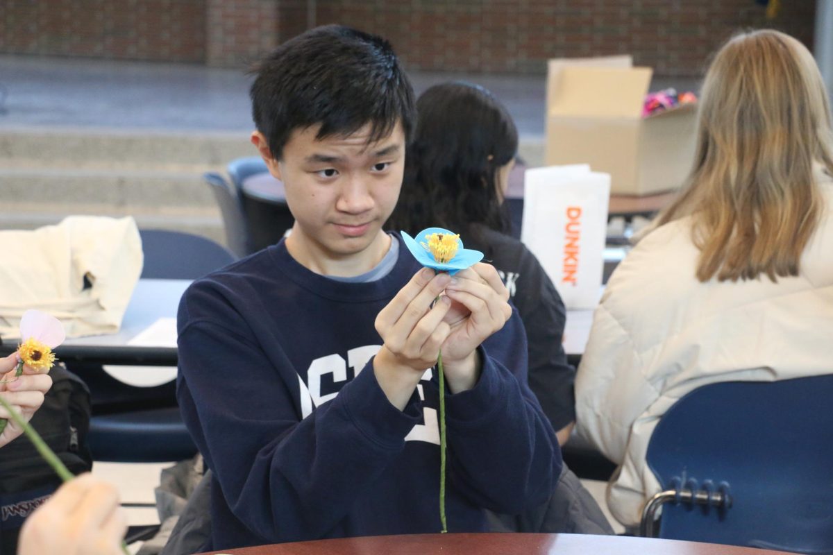 Key Club member Mason Zhang makes a flower at the Key Club meeting on Feb. 19. Zhang said he really enjoyed being a member of Key Club and said he’s gained valuable volunteer experience while in the organization.