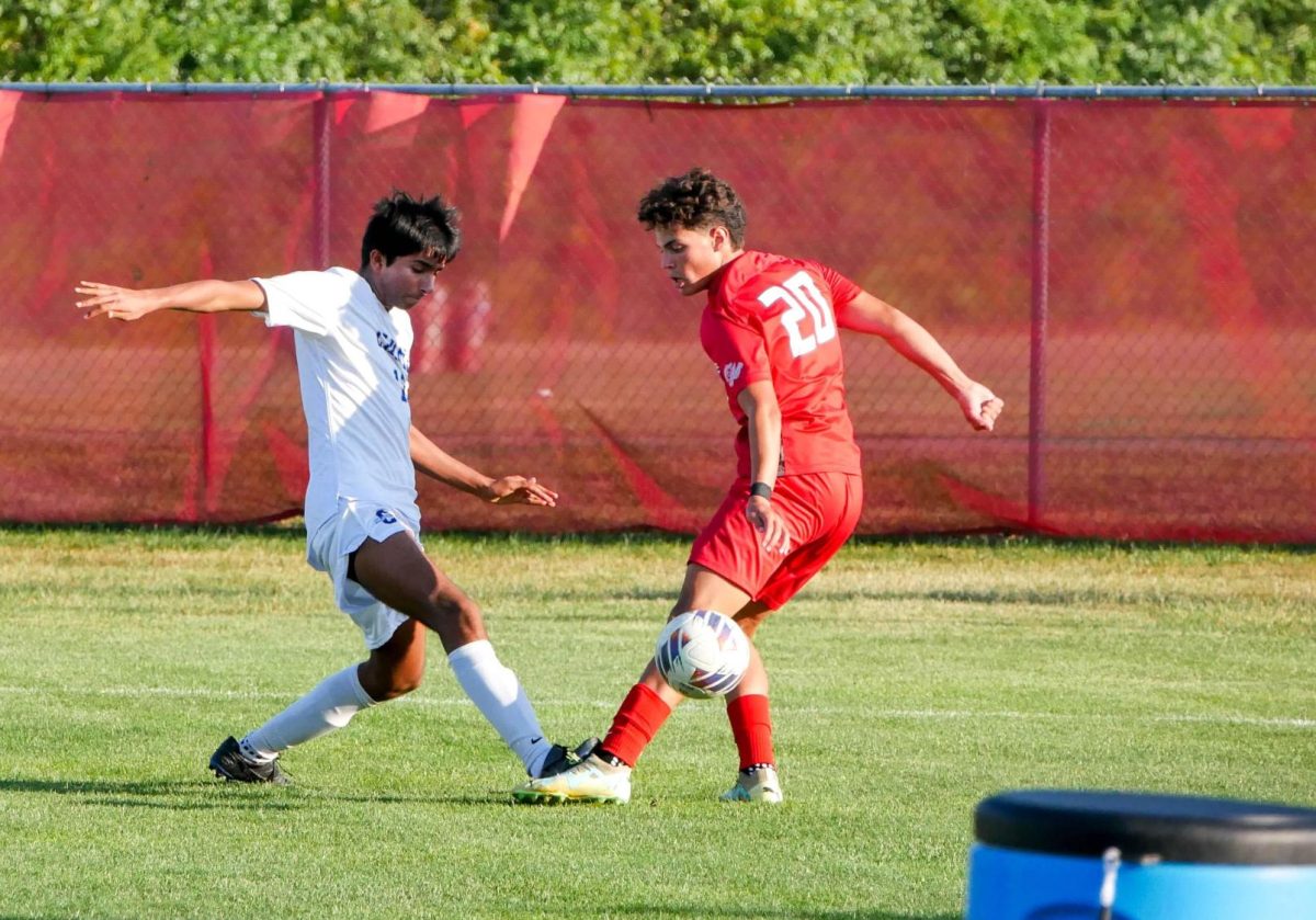 Shawn Thind steals the ball from another player during a soccer game on Oct. 9. “We both play defending center back in soccer, so we’re usually compared when it comes to things like our playing styles,” Shawn said. (Submitted Photo: Shawn Thind)