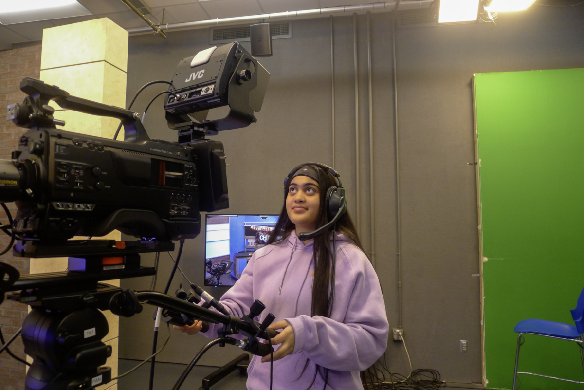 Junior Gurleen Kaur operates a studio camera in the CHTV media room while helping prepare for an upcoming broadcast. Kaur said the media should not be censored and that open access to information through the media allows audiences to think freely.