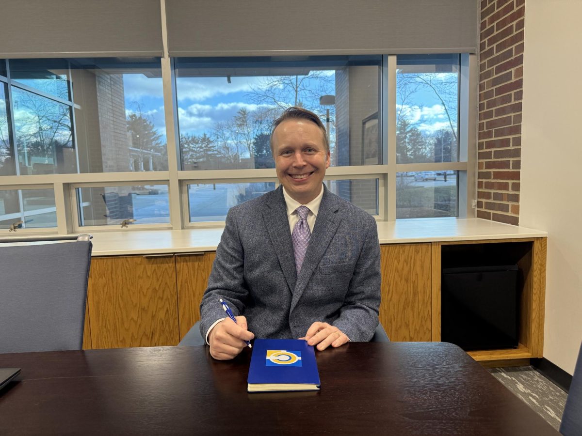 Superintendent Tom Oestreich smiles in a conference room on Jan. 15. Oestreich said the work-based learning internship program has made working more accessible to more students. 