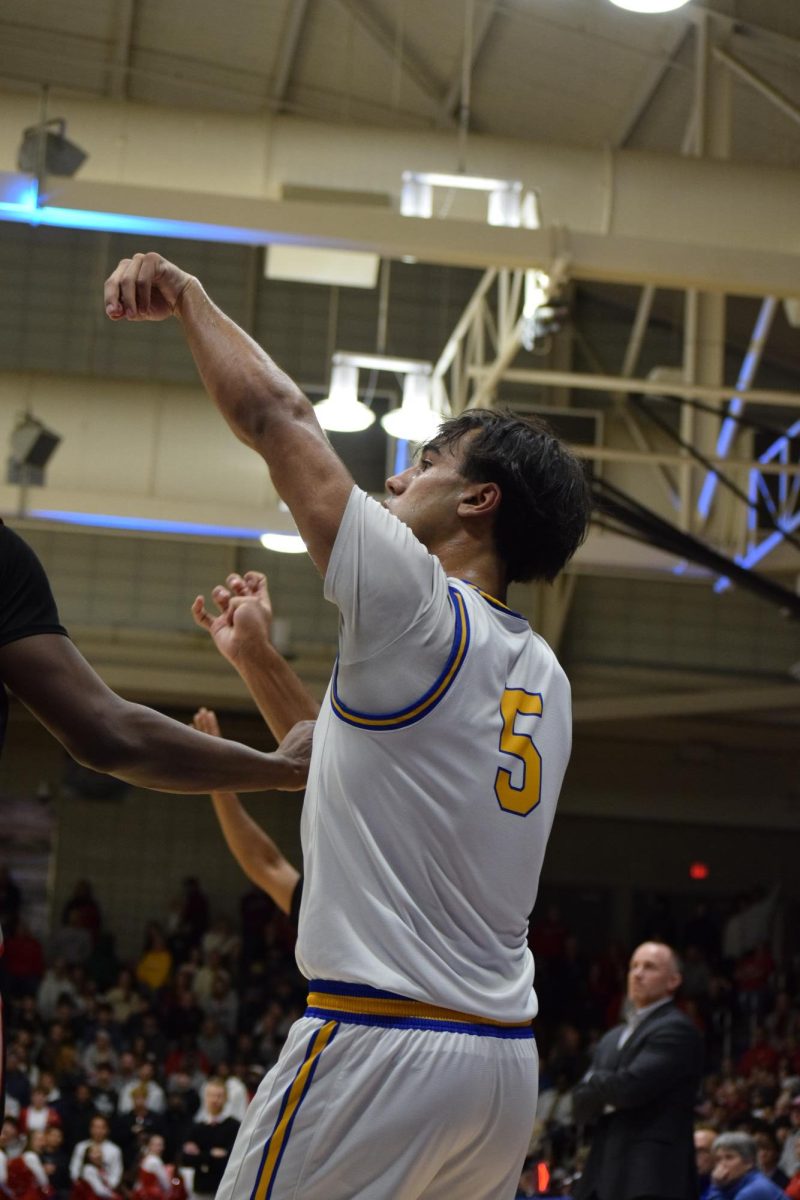Junior Aiden Dickerson shoots a basketball during the men's basketball game on Jan. 31. Fishers beat Carmel 53-50.