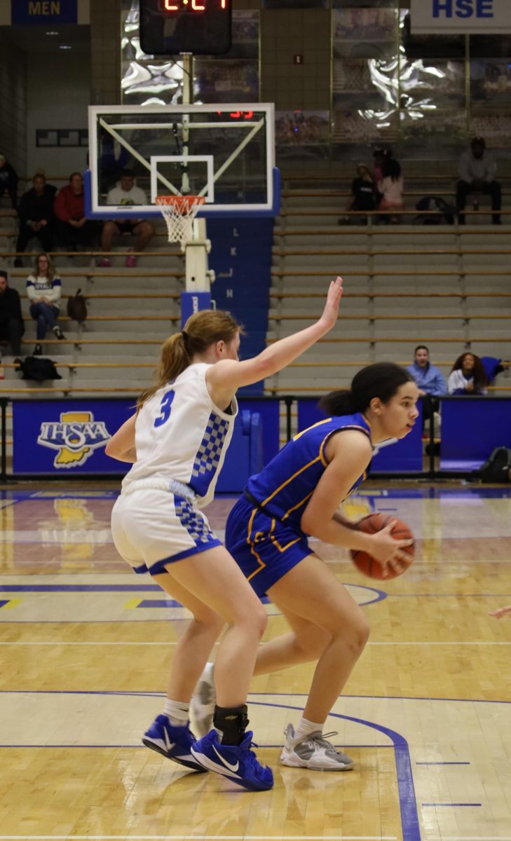 Senior Sydney Bonds goes up against a defender during the fourth quarter of the Sectional game on Feb. 7. She drove to the basket and passed the ball to an open teammate that was ready to shoot the ball.