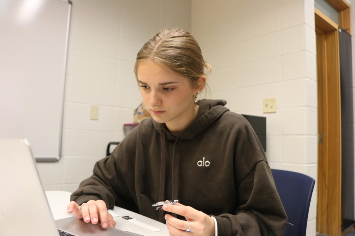 Senior Elle Evard creates a wristband for her Biomedical Innovations class on Feb. 26. "This wristband will help people understand the causes for their stress through sensors and an app I'm coding," Evard said. 