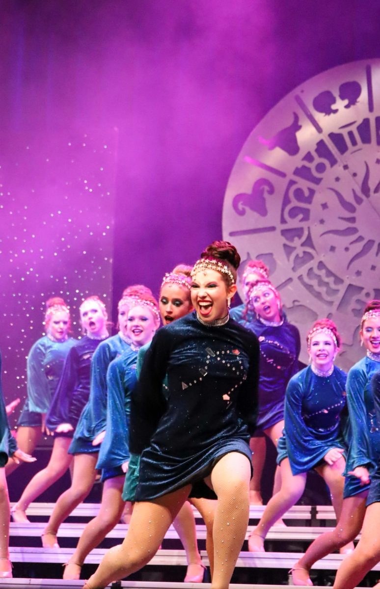 Accents member and senior Kat Mccall dances onstage during the Evening of Show Choir. The performance featured songs inspired by the 12 zodiac signs.