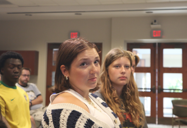 Senior Cat Robinson remains attentive to the school board meeting on Aug. 26, 2024. The students attended the meeting in support of their classmates who would be providing public comments.