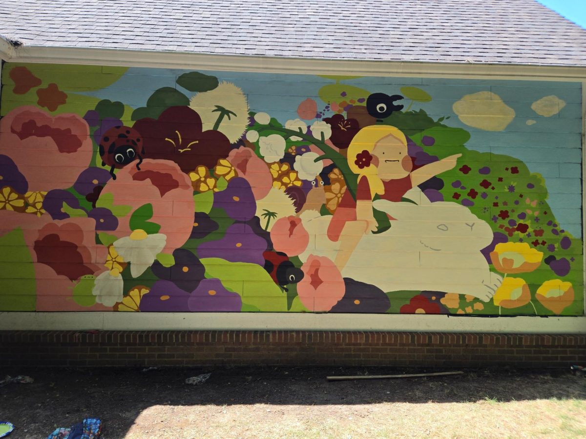 The finished mural created by Artist’s Association club officers and members is displayed on a home near the Monon Trail. Yu said the club officers designed a mural incorporating Studio Ghibli style. Yu said, “This activity was a fun way to connect with the community and I really loved how it turned out.”