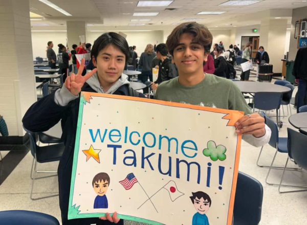 Exchange student Takumi Michibata (left) and senior Ismail Kheiri (right) greet each other during the first day of the exchange program in the main cafeteria on March 17. Michibata took part in the exchange program where the cities of Carmel and Seikyo send students every other year. (Submitted: Ismail Kheiri)