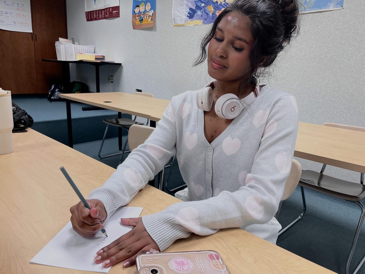 Cards for Kids Club president and junior Rithikka Anand writes a birthday card during a club meeting. Club members create handmade cards that are shipped to organizations supporting children in need.