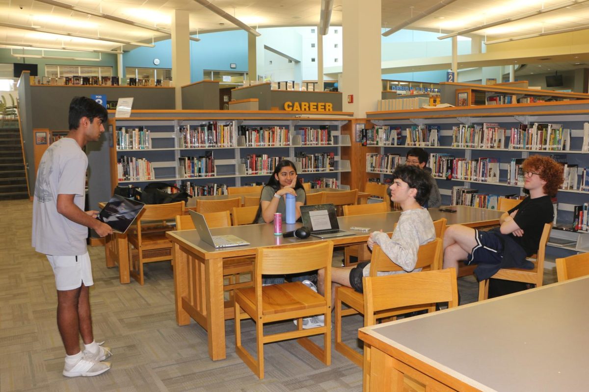 Senior Nikhil Gupta teaches debate to students on March 31. Gupta said being an only child made him more independent and has influenced him to do individual debate and tennis events.